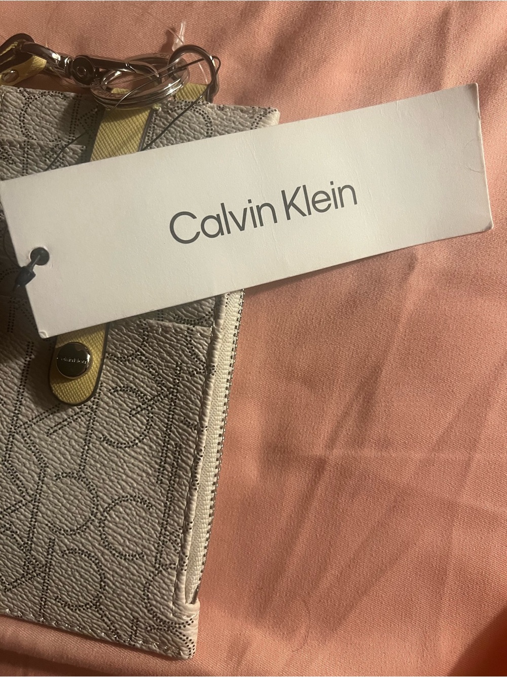 Calvin Klein cream color Logo-Print Wristlet with Yellow Accent
